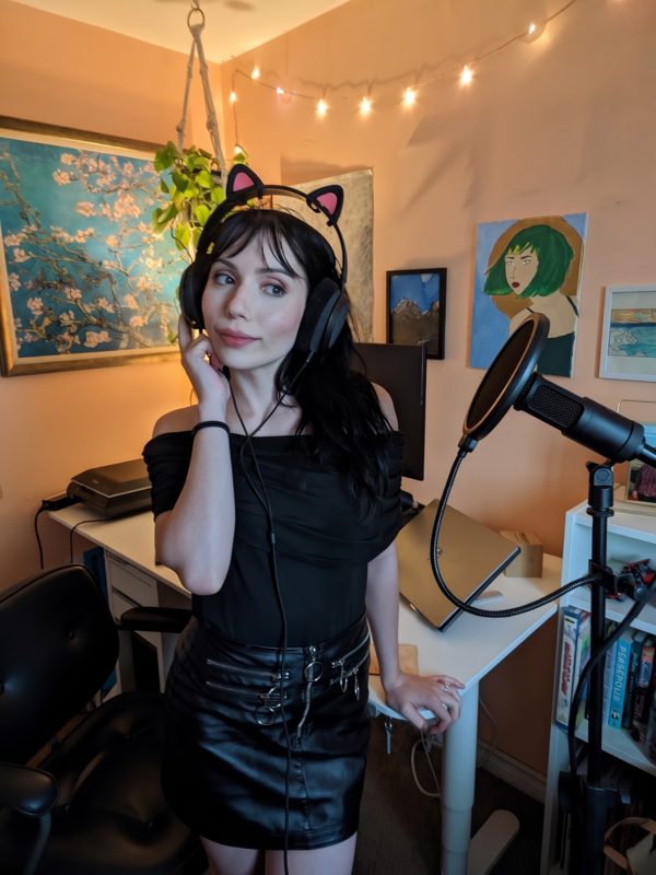 Rose wearing cat ear headphones at a microphone