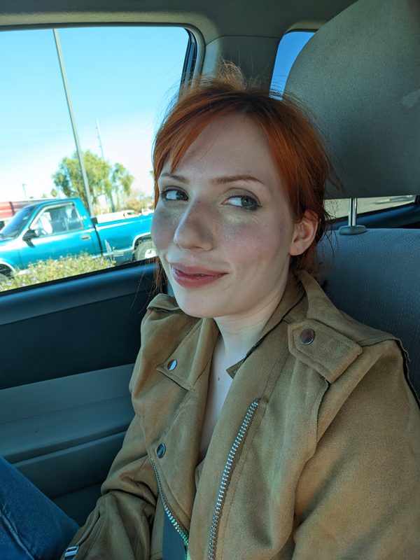 Rose with red hair in a car